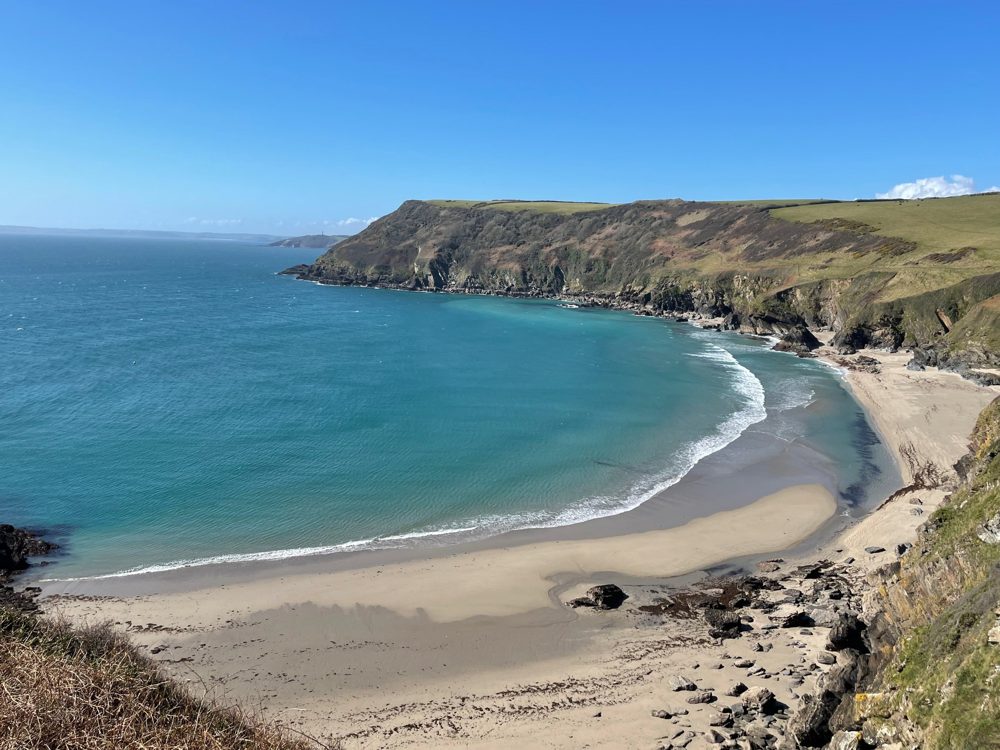 A sweep of sand and turquoise sea on the south Cornish coast